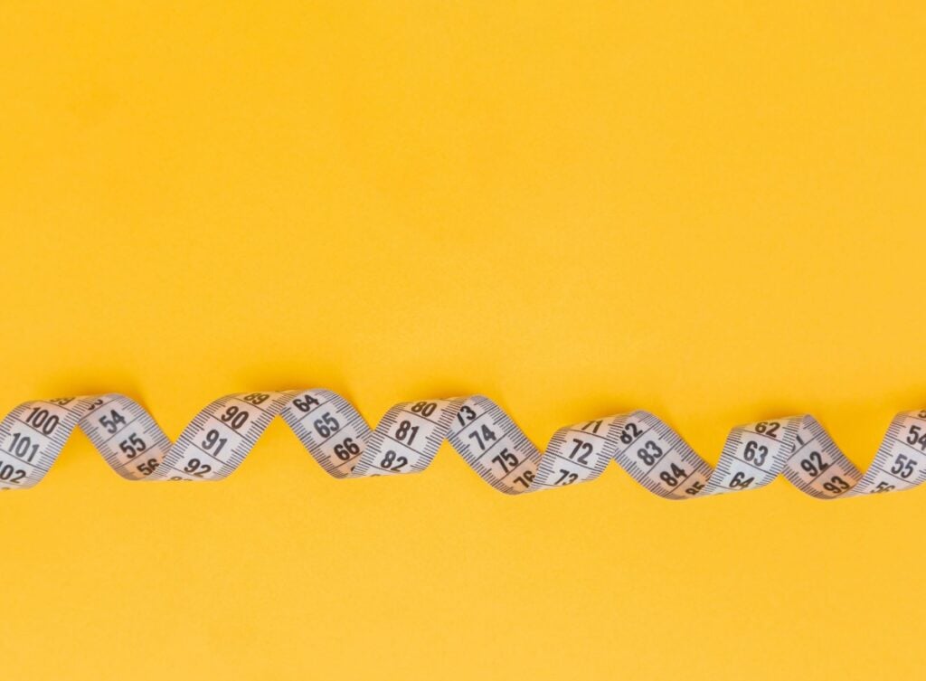 spiral tape measure yellow background