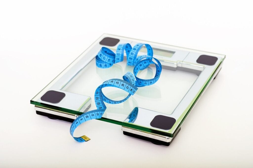 tape measure on top of a weighing scale