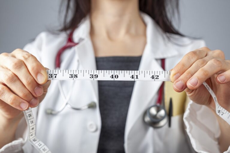doctor holding tape measure