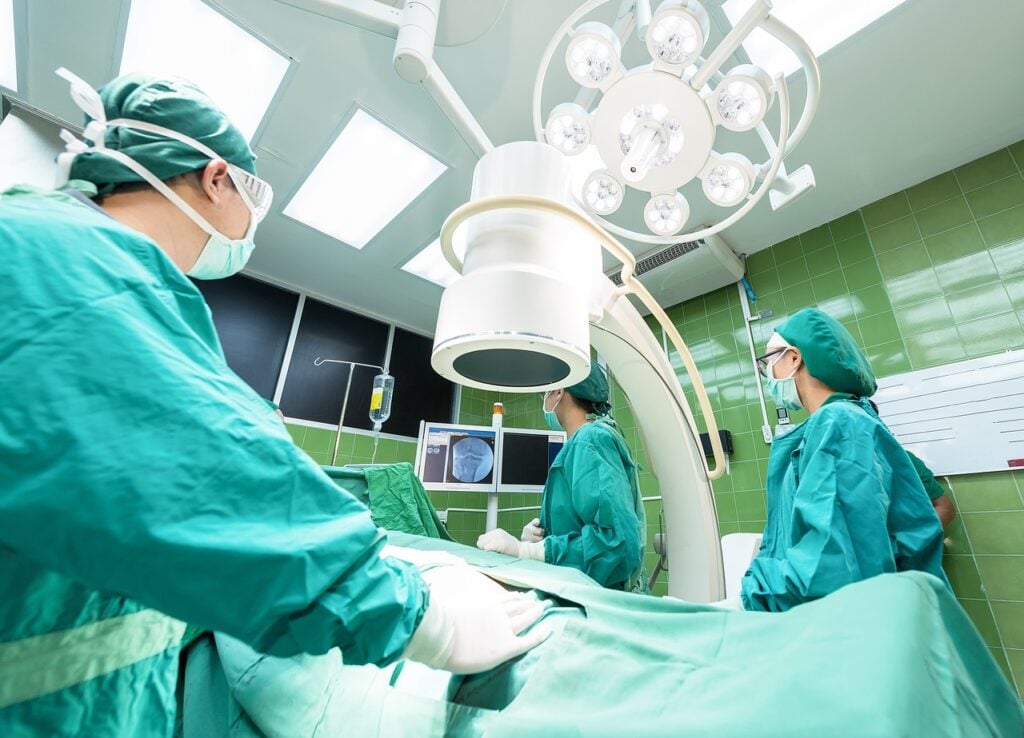 Surgeons performing a procedure, representing recovery after gastric bypass surgery in a sterile operating room.