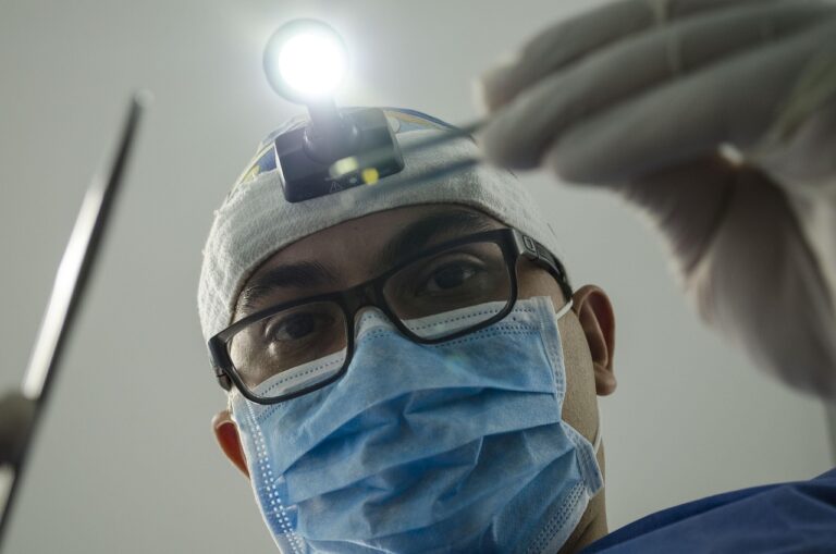 Surgeon in mask and headlamp working, illustrating bariatric surgery option over Ozempic.